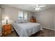 Bright bedroom with window and wood nightstand at 8015 W Calhoun Pl, Littleton, CO 80123