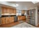 Updated kitchen with light wood cabinets and granite counters at 8015 W Calhoun Pl, Littleton, CO 80123