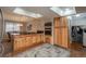 Updated kitchen with light wood cabinets and granite counters at 8015 W Calhoun Pl, Littleton, CO 80123