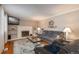 Cozy living room featuring a fireplace and ample seating at 8015 W Calhoun Pl, Littleton, CO 80123