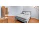 Cozy bedroom with wood floors, a gray bed, and a colorful floor lamp at 175 Harrison St, Denver, CO 80206
