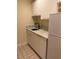 Stylish wet bar area with marble countertops, white cabinets, and a modern black faucet at 175 Harrison St, Denver, CO 80206