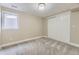 Bedroom featuring light gray carpet and neutral gray paint, with a large closet at 13883 E Radcliff Pl, Aurora, CO 80015