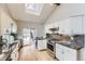 Bright kitchen with white cabinets, granite countertops, and stainless steel appliances at 13883 E Radcliff Pl, Aurora, CO 80015