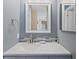Bathroom featuring a gray vanity, chrome fixtures, and a decorative backsplash at 534 E 7Th Ave # 101, Denver, CO 80203