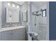 Bathroom featuring a walk-in shower, gray vanity, and updated lighting at 534 E 7Th Ave # 101, Denver, CO 80203