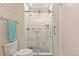 Tiled shower with pebble floor, glass door, and chrome fixtures at 534 E 7Th Ave # 101, Denver, CO 80203
