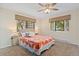 Bedroom with two windows allowing ample natural light and an orange patterned bedspread at 534 E 7Th Ave # 101, Denver, CO 80203