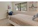 Cozy bedroom featuring a comfortable bed, work desk, and window to the outside at 534 E 7Th Ave # 101, Denver, CO 80203