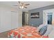 A bedroom features carpeted floor, a ceiling fan, and a closet with sliding doors at 534 E 7Th Ave # 101, Denver, CO 80203