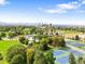 Beautiful aerial perspective showcasing City Park with tennis courts and the Denver skyline, ideal for recreation and relaxation at 534 E 7Th Ave # 101, Denver, CO 80203