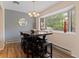 Well-lit dining space with a large window and elegant chandelier at 534 E 7Th Ave # 101, Denver, CO 80203