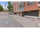 Attached garage with gray door and driveway ramp at 534 E 7Th Ave # 101, Denver, CO 80203