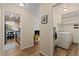 Hallway leading to open concept living, laundry area, and kitchen at 534 E 7Th Ave # 101, Denver, CO 80203