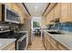 Galley kitchen with stainless steel appliances and ample cabinet space at 534 E 7Th Ave # 101, Denver, CO 80203