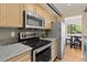 Modern kitchen featuring stainless steel appliances and granite countertops at 534 E 7Th Ave # 101, Denver, CO 80203