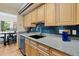 Stylish kitchen with updated countertops, tile backsplash, and stainless steel appliances at 534 E 7Th Ave # 101, Denver, CO 80203