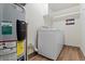 Laundry area featuring modern washer and dryer set, water heater, and shelving at 534 E 7Th Ave # 101, Denver, CO 80203