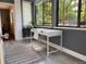 Bright, minimalist office area features a modern white desk, chair, and a stylish rug with large windows for natural light at 534 E 7Th Ave # 101, Denver, CO 80203