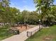 Playground featuring swings and walking path with a fenced-in perimeter at 534 E 7Th Ave # 101, Denver, CO 80203