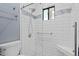 Walk-in shower with white subway tile, mosaic accent stripe, and pebble-style floor at 534 E 7Th Ave # 101, Denver, CO 80203
