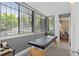 Bright sunroom with large windows and a peaceful view of the outdoors at 534 E 7Th Ave # 101, Denver, CO 80203