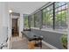 Serene sunroom filled with natural light and views of the surrounding greenery at 534 E 7Th Ave # 101, Denver, CO 80203