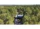 Stunning aerial view of a secluded home surrounded by mature trees, offering a private and serene living environment at 5777 County Road 154, Elizabeth, CO 80107