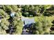 Aerial view of a home nestled among mature trees, featuring a spacious lot and serene setting, offering privacy at 5777 County Road 154, Elizabeth, CO 80107