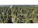 Expansive aerial view of a heavily treed property in a mountain community at 5777 County Road 154, Elizabeth, CO 80107