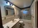 Bathroom with tile flooring, a single vanity with ample storage, frosted glass shower, and wallpaper trim at 5777 County Road 154, Elizabeth, CO 80107