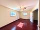 Bedroom with hardwood floors, natural light, two windows, and an open doorway to another room at 5777 County Road 154, Elizabeth, CO 80107