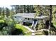 Two-story home with a spacious deck, complemented by lush greenery and landscaping offering both style and outdoor living space at 5777 County Road 154, Elizabeth, CO 80107
