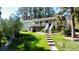 Two-story home with a rear deck, complemented by a sloping lawn and mature trees creating a serene outdoor space at 5777 County Road 154, Elizabeth, CO 80107