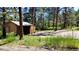 Exterior view of building near dirt road, surrounded by a wooded area at 5777 County Road 154, Elizabeth, CO 80107
