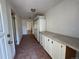 Hallway featuring tile flooring, built in storage cabinets, and neutral colored walls leading to an open doorway at 5777 County Road 154, Elizabeth, CO 80107