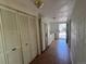 Hallway showcasing tile flooring, built-in storage cabinets, and white walls, leading to an exterior door at 5777 County Road 154, Elizabeth, CO 80107