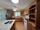 Spacious kitchen showcasing wood cabinets, a skylight, and ample counter space at 5777 County Road 154, Elizabeth, CO 80107