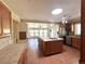 Open kitchen featuring an island with cooktop, stainless steel appliances, tile countertops, and tile flooring at 5777 County Road 154, Elizabeth, CO 80107