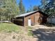 Exterior of an outbuilding with a sliding door, service door, and bench at 5777 County Road 154, Elizabeth, CO 80107