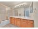 Bathroom featuring wood cabinets, a large mirror and a glass enclosed bathtub shower at 4006 E Geddes Cir, Centennial, CO 80122