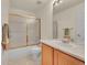 Full bathroom featuring a shower with sliding doors, a sink with a wooden cabinet, and neutral decor at 4006 E Geddes Cir, Centennial, CO 80122