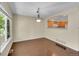 Open dining area with dark wood floors, adjacent to the kitchen with natural light from a window at 4006 E Geddes Cir, Centennial, CO 80122