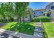 Well-maintained home with lush green lawn and mature trees, featuring a covered front entrance at 4006 E Geddes Cir, Centennial, CO 80122
