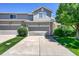 Exterior elevation showing a well-maintained townhome with attached two-car garage at 4006 E Geddes Cir, Centennial, CO 80122
