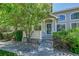 Charming home featuring a covered front entrance, lush landscaping and a secure storm door at 4006 E Geddes Cir, Centennial, CO 80122