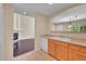 Bright kitchen featuring ample countertop space, a double sink, and warm-toned cabinetry at 4006 E Geddes Cir, Centennial, CO 80122