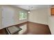 Open living room features dark wood floors, natural light, and a white entry door at 4006 E Geddes Cir, Centennial, CO 80122