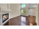 Bright living room with a fireplace, large windows, and hardwood floors, creating a welcoming and comfortable space at 4006 E Geddes Cir, Centennial, CO 80122