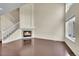 Bright living room featuring dark wood floors, a fireplace, and a staircase leading to the upper level at 4006 E Geddes Cir, Centennial, CO 80122